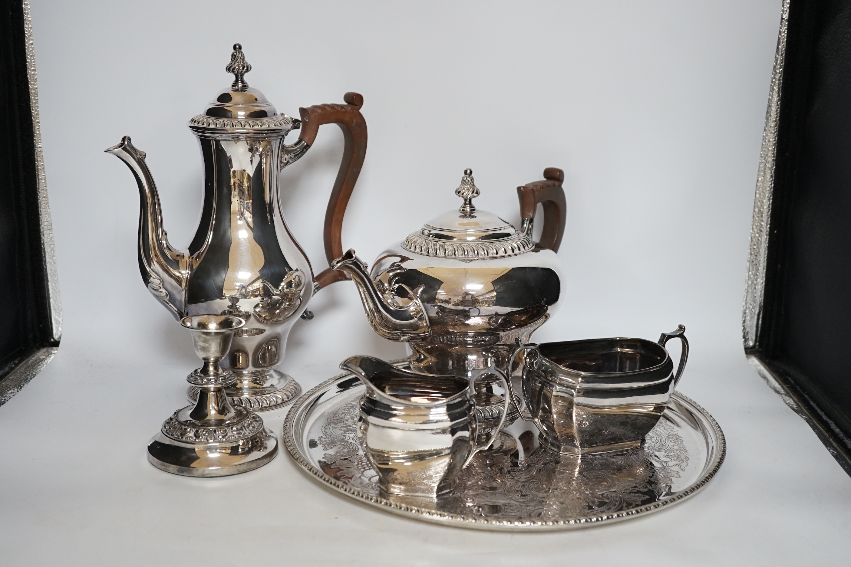 A large quantity of plated wares including a four piece tea and coffee set, other plated wares and cased pan scale